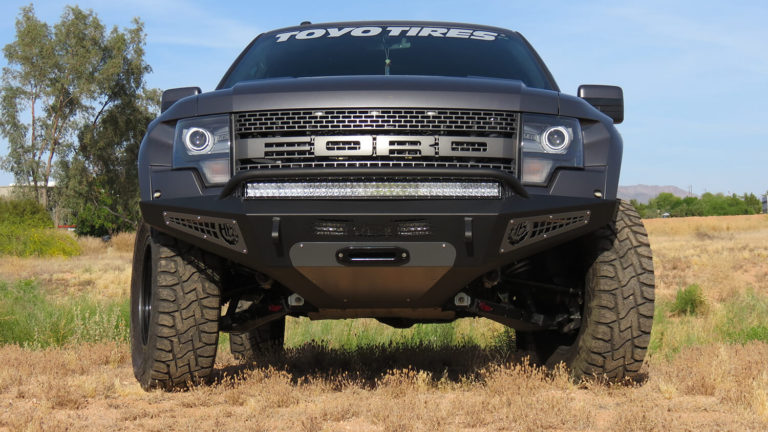 2010 - 2014 Ford Raptor HoneyBadger Front Bumper with Winch Mount and 40" RDS LED bar mounts and 20" LED bar mount in lower with HB logo cutout with 10" LED bar mounts and Dually mounts in sides panels in Hammer Black with Satin Black panels