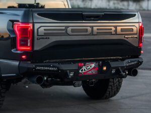 Ford Raptor HoneyBadger Rear Bumper with  Tow Hooks and BACKUP SENSORS with 10" SR LED light bar mounts and Dually mounts in Hammer Black with Satin Black panels.