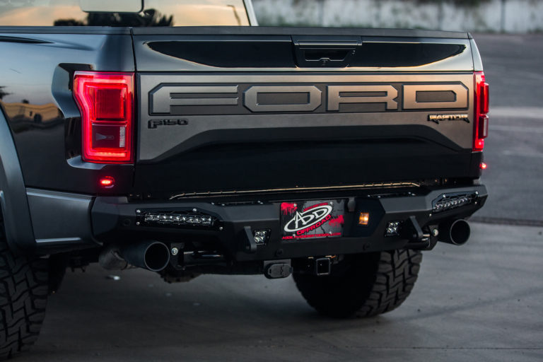 Ford Raptor HoneyBadger Rear Bumper with  Tow Hooks and BACKUP SENSORS with 10" SR LED light bar mounts and Dually mounts in Hammer Black with Satin Black panels.